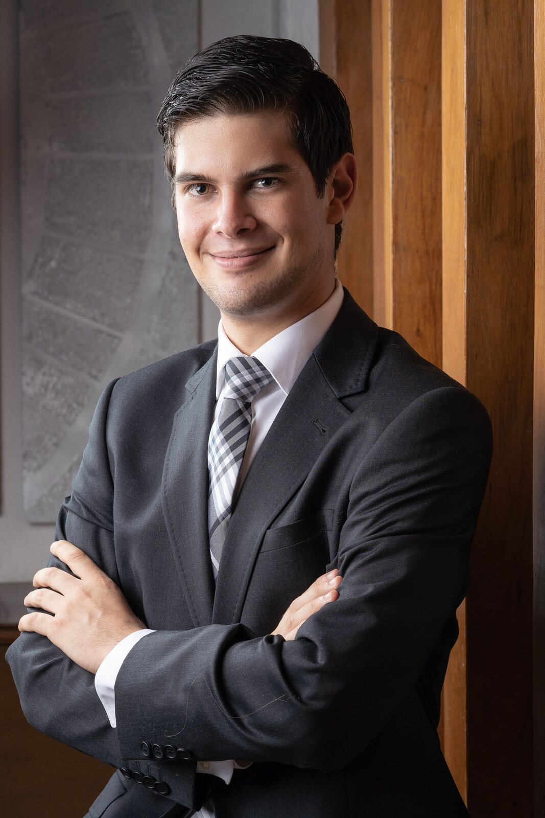 Retrato corporativo de un hombre de traje con los brazos cruzados